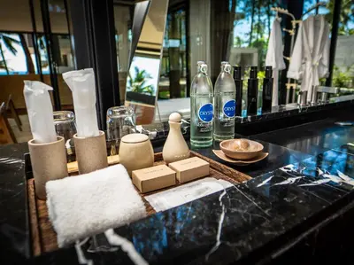 a counter with bottles and other items on it at Grand Villa Noi in Natai Beach