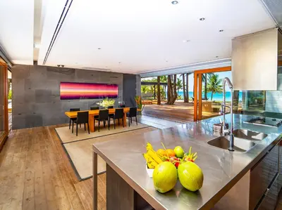 a kitchen and dining room with a table with fruit on it at Grand Villa Noi in Natai Beach