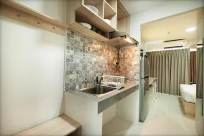 a small kitchen with a sink and a bathroom at beHOME Phuket in Nai Yang Beach