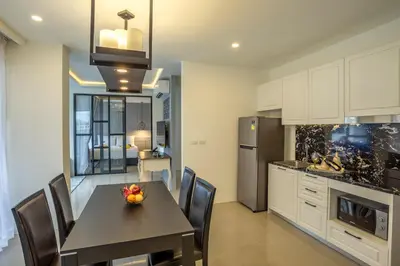 a kitchen and dining room with a table and chairs at Surin Beach Residence - Official Account in Surin Beach