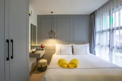 a bedroom with a bed with bananas on it at Surin Beach Residence - Official Account in Surin Beach