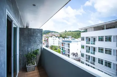 an apartment balcony with a view of a city at Happy 99 Guest house in Patong Beach