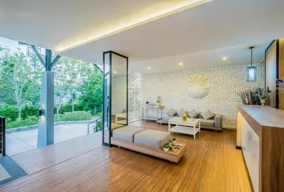 a living room with a couch and a table at The Rubber Hotel Phuket in Thalang