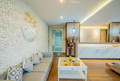 a living room with a couch and a table at The Rubber Hotel Phuket in Thalang