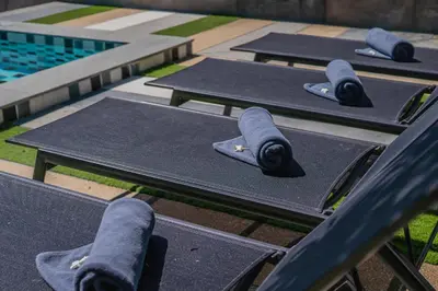 a row of ping pong tables with napkins on them at The Rubber Hotel Phuket in Thalang