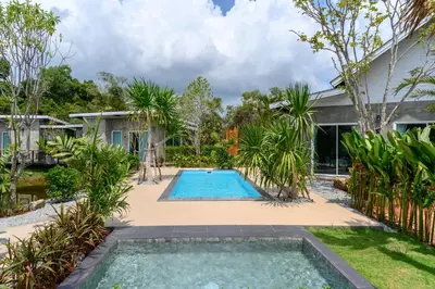 a swimming pool in the backyard of a house at Loftpical Resort in Phuket Town