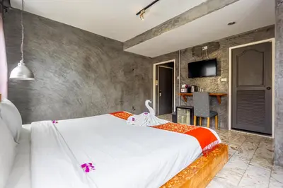 a bedroom with a large white bed in a room at UNOTEL Karon Beach in Karon Beach
