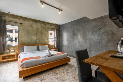 a bedroom with a large bed and a table at UNOTEL Karon Beach in Karon Beach
