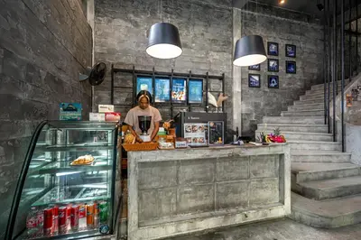a woman standing behind a counter in a store at UNOTEL Karon Beach in Karon Beach
