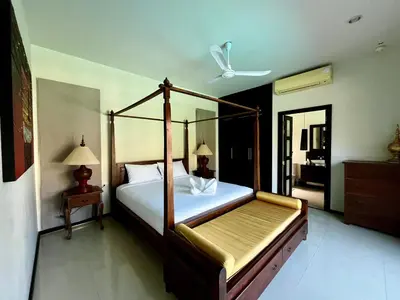 a bedroom with a canopy bed and a mirror at 3bdr Pool villa Naiharn KOK by Capital Pro in Rawai Beach