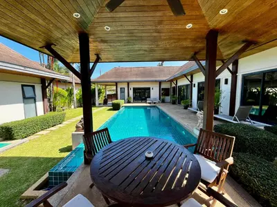 a patio with a table and chairs and a swimming pool at 3bdr Pool villa Naiharn KOK by Capital Pro in Rawai Beach