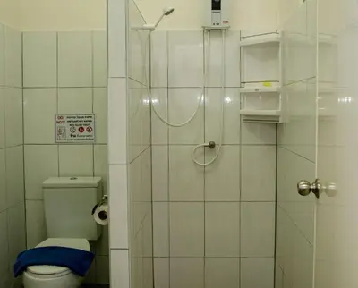 a bathroom with a shower and a toilet in it at Allstar Guesthouse in Karon Beach