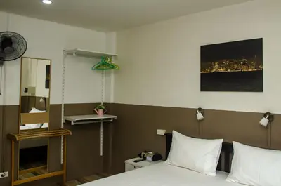 a bedroom with a bed and a city skyline at Allstar Guesthouse in Karon Beach
