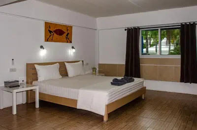 a bedroom with a large bed and a window at Allstar Guesthouse in Karon Beach