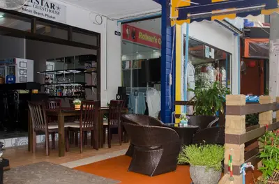 a restaurant with chairs and a table in front of it at Allstar Guesthouse in Karon Beach