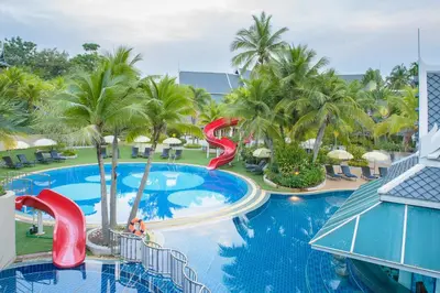a view of a resort pool with a water slide at Chada Thai Village in Ao Nang Beach