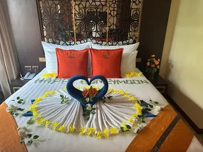 a bed with two heart shaped decorations on it at BAB ALHARA HOTEL in Patong Beach