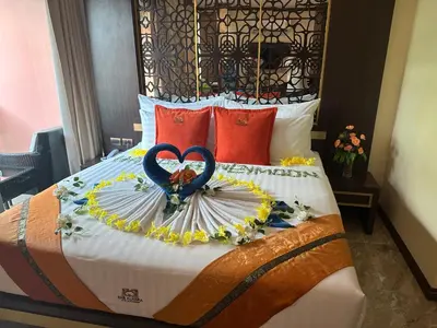 a bed with two heart shaped decorations on it at BAB ALHARA HOTEL in Patong Beach