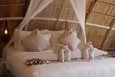 a bed with three stuffed animals on it at Jaiyen Eco Resort in Ko Yao Noi