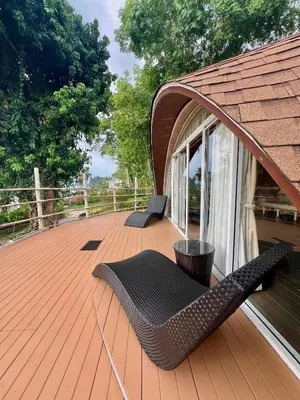a wooden deck with a bench on a house at Jaiyen Eco Resort in Ko Yao Noi