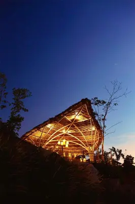a large wooden building with lights on it at night at Jaiyen Eco Resort in Ko Yao Noi