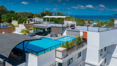 an aerial view of a building with a swimming pool at KK Karon Kata Boutique Hotel in Kata Beach