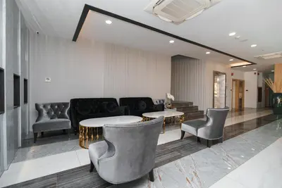 a lobby with chairs and a table and a couch at KK Karon Kata Boutique Hotel in Kata Beach
