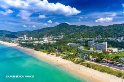 an aerial view of the beach and buildings at KK Karon Kata Boutique Hotel in Kata Beach