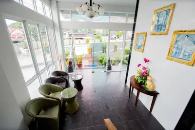 a living room with chairs and a table with flowers on it at Aonang Ocean View Studio ( The Sea Condo ) in Ao Nang Beach