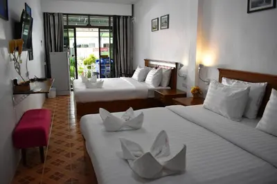 a hotel room with two beds with white sheets at Sala Bua Room in Karon Beach