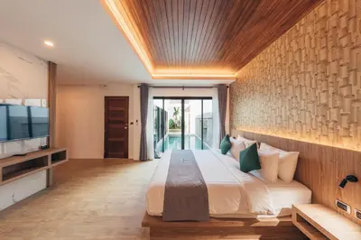 a bedroom with a large bed and a television at Poonsiri Varich Pool Villa Aonang in Ao Nang Beach