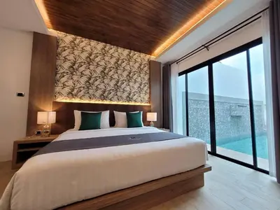 a bedroom with a large bed and a large window at Poonsiri Varich Pool Villa Aonang in Ao Nang Beach