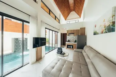 a living room with a large couch and a television at Poonsiri Varich Pool Villa Aonang in Ao Nang Beach