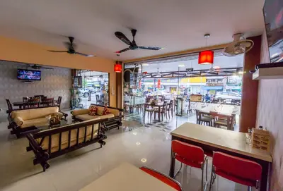 a restaurant with tables and chairs in a room at Mellow Space Boutique Rooms in Karon Beach