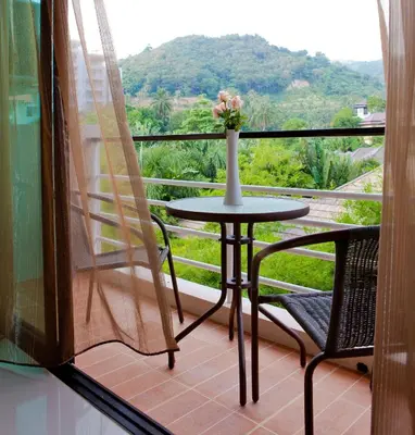 a table and chairs on a balcony with a view at Mellow Space Boutique Rooms in Karon Beach