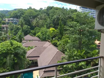 a balcony with a view of trees and houses at Mellow Space Boutique Rooms in Karon Beach