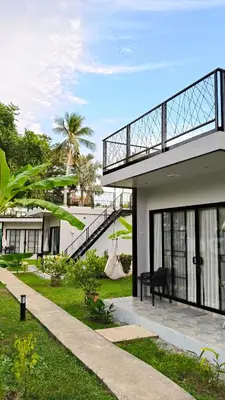 a view of a house with a balcony at Coconut Wells Phuket in Chalong