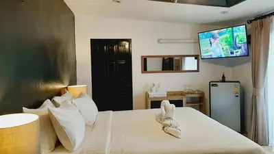 a bedroom with a bed with a tv on the wall at Big Boys' Bed & Burger - Patong Beach in Patong Beach