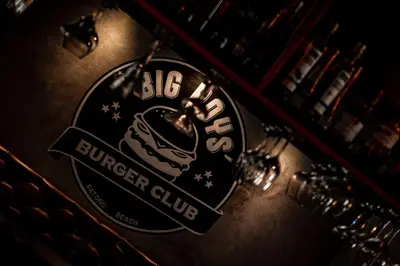 a sign that says big burger club on a bar at Big Boys' Bed & Burger - Patong Beach in Patong Beach