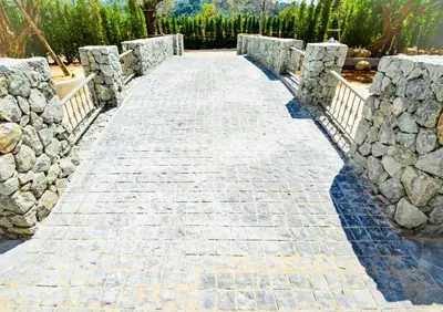 a stone path with a stone wall and a stone bridge at The Title Residence NaiYang in Nai Yang Beach