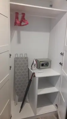 a white closet with an umbrella and a radio at The Title Residence NaiYang in Nai Yang Beach