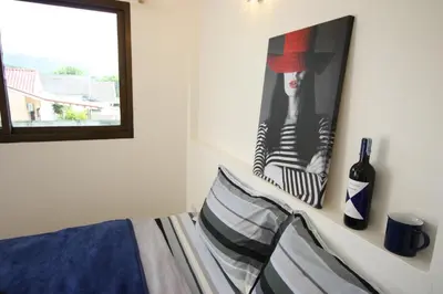 a bedroom with a bed and a picture on the wall at Sun & Sea Nai Yang Phuket in Nai Yang Beach
