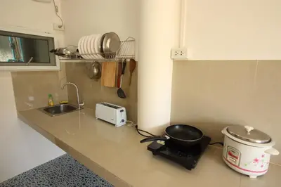 a kitchen with a counter with a pot and a toaster at Sun & Sea Nai Yang Phuket in Nai Yang Beach