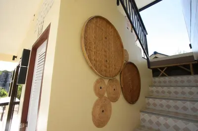 a wall with three wooden plates on a wall at Sun & Sea Nai Yang Phuket in Nai Yang Beach