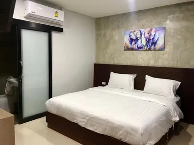 a bedroom with a bed and a air conditioner at Easy Loft Hostel in Phuket Town