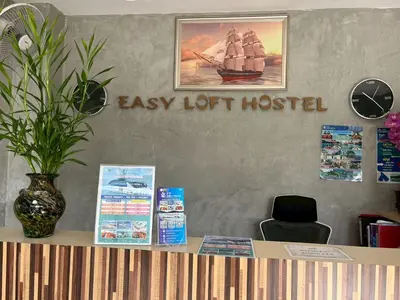 a desk with a sign that reads easy lot hospital at Easy Loft Hostel in Phuket Town