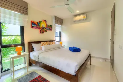 a bedroom with a bed and a large window at 5bdr Pool Villa In Laguna Park #45 by Capital Pro in Bang Tao Beach