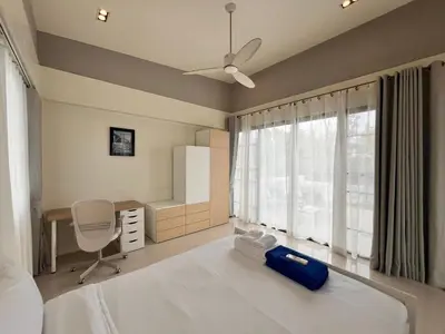 a bedroom with a bed and a desk and a window at 5bdr Pool Villa In Laguna Park #45 by Capital Pro in Bang Tao Beach