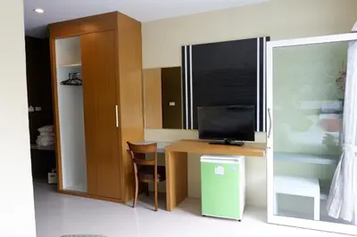 a room with a desk with a television and a window at Phi Phi Maiyada Resort in Phi Phi Don