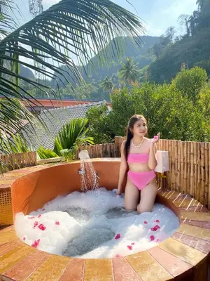 a young girl sitting in a hot tub at Phi Phi Maiyada Resort in Phi Phi Don